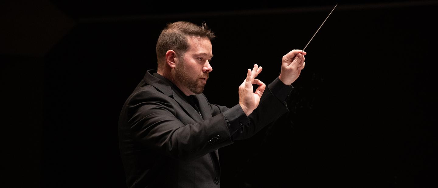 Man conducting on stage