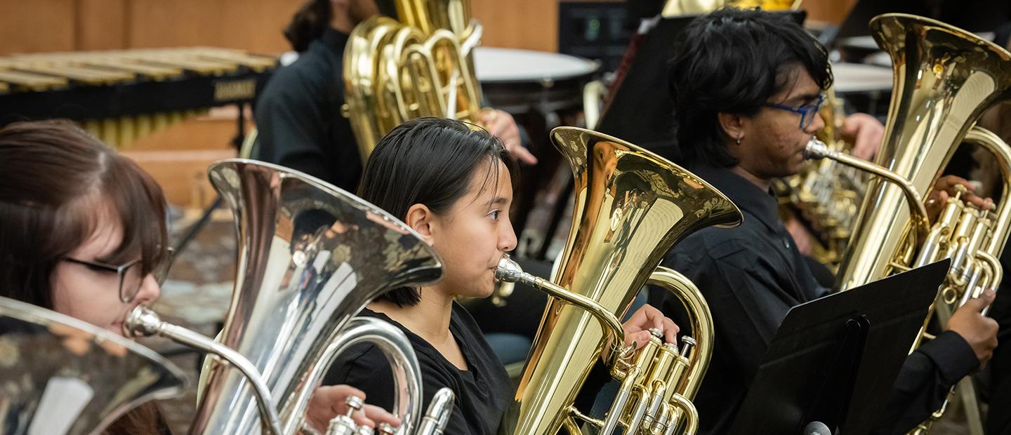 音乐ians playing brass instruments in an ensemble.